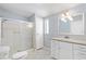 This bathroom has a shower, vanity and sink, and neutral wall color and tile at 518 Saint Andrews Blvd, Lady Lake, FL 32159