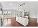 Open-concept kitchen and living area with an island, hardwood floors, and lots of natural light at 518 Saint Andrews Blvd, Lady Lake, FL 32159