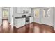 A cozy kitchen with white cabinets, stainless steel appliances, and hardwood floors at 518 Saint Andrews Blvd, Lady Lake, FL 32159