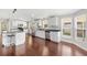 Bright kitchen featuring stainless steel appliances, white cabinetry and an island with bar seating at 518 Saint Andrews Blvd, Lady Lake, FL 32159