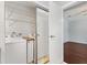 Convenient laundry area with washer, dryer, and built-in storage shelves for an organized space at 518 Saint Andrews Blvd, Lady Lake, FL 32159