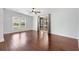 Bright living area featuring hardwood floors, a ceiling fan, and sliding glass doors leading to a patio at 518 Saint Andrews Blvd, Lady Lake, FL 32159