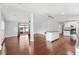 Open-concept living area with hardwood floors, vaulted ceilings, decorative columns, and access to the kitchen at 518 Saint Andrews Blvd, Lady Lake, FL 32159