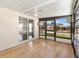Relaxing sunroom featuring wood floors, fan, and sliding door at 518 Saint Andrews Blvd, Lady Lake, FL 32159