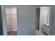 Hallway with view to closet and bathroom, showcasing modern fixtures and ample storage at 5323 Nw 8Th Pl, Ocala, FL 34482