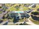 Aerial view of community buildings with a pool, tennis courts, and verdant landscaping at 5340 Nw 26Th Ln, Ocala, FL 34482