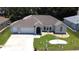 Inviting single-story home with manicured lawn, stone landscape detail, and a spacious driveway at 5340 Nw 26Th Ln, Ocala, FL 34482