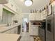 Bright kitchen features white cabinetry, modern stainless steel appliances and tile flooring at 5340 Nw 26Th Ln, Ocala, FL 34482