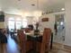 Open-concept living area showcasing a stylish dining set, views of the living room, and a glimpse of the kitchen at 5340 Nw 26Th Ln, Ocala, FL 34482