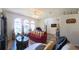 Bright living room with large windows, hardwood floors, and a cozy seating arrangement at 5340 Nw 26Th Ln, Ocala, FL 34482