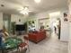 Open-concept living room featuring bright interiors, tile flooring, and views into the kitchen at 5340 Nw 26Th Ln, Ocala, FL 34482
