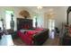 Spacious main bedroom featuring a large bed, hardwood floors, and access to ensuite bathroom at 5340 Nw 26Th Ln, Ocala, FL 34482