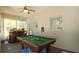An entertainment area with a pool table, bar area, and natural light from the windows at 5340 Nw 26Th Ln, Ocala, FL 34482