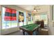 Sunroom with a billiard table, ceiling fan, stylish bar, and doors that lead to the backyard at 5340 Nw 26Th Ln, Ocala, FL 34482