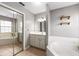 Bright bathroom featuring a garden tub, a vanity with storage, and a large mirror at 5437 Se 34Th St, Ocala, FL 34480