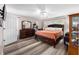 Comfortable bedroom with wood-look flooring, natural light, dresser, and closet, offering a relaxing space at 5437 Se 34Th St, Ocala, FL 34480