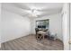 Bright bedroom with light walls, laminate floors, and a window with natural light at 5437 Se 34Th St, Ocala, FL 34480