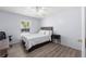 Cozy bedroom with light blue walls, laminate floors, and a queen-sized bed at 5437 Se 34Th St, Ocala, FL 34480