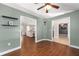 A versatile empty room with wood floors, featuring doorway views to other rooms and decorative wall shelves at 5437 Se 34Th St, Ocala, FL 34480