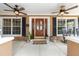 Welcoming front porch with stylish decor, ceiling fans, and ample seating at 5437 Se 34Th St, Ocala, FL 34480