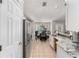 Bright kitchen featuring stainless steel appliances, tile flooring, and a view into a sunlit dining area at 5437 Se 34Th St, Ocala, FL 34480