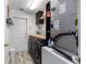 Functional laundry room with a front-load washer and dryer and overhead shelving at 5437 Se 34Th St, Ocala, FL 34480