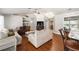 Spacious living room with wood floors, a fireplace, and a built-in bar area, perfect for entertaining at 5437 Se 34Th St, Ocala, FL 34480