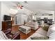 Spacious living room with hardwood floors, skylight, and seamless flow to the kitchen at 5437 Se 34Th St, Ocala, FL 34480