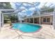 Inviting screened-in pool area with a spacious deck, perfect for outdoor relaxation at 5437 Se 34Th St, Ocala, FL 34480