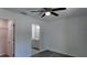 A bedroom with light gray wood-look floors adjacent to a bathroom with a white vanity and framed mirror at 5635 Nw 2Nd St, Ocala, FL 34482