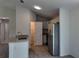The kitchen features white cabinets, stainless steel appliances, granite countertops, and wood-look flooring at 5635 Nw 2Nd St, Ocala, FL 34482