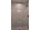 Close up of the modern walk-in shower with marble tiles and chrome fixtures at 5635 Nw 2Nd St, Ocala, FL 34482