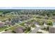 Wide aerial shot showing the layout of a residential community and surrounding greenery at 5653 Sw 50Th Ter, Ocala, FL 34474