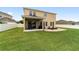 Large backyard featuring covered patio, patio, and manicured lawn at 5653 Sw 50Th Ter, Ocala, FL 34474