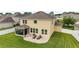 Aerial view of backyard with patio, lounge chairs, screened porch, and well-maintained lawn at 5653 Sw 50Th Ter, Ocala, FL 34474