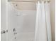 Clean bathroom with white tile shower, bathtub, and white shower curtain at 5653 Sw 50Th Ter, Ocala, FL 34474