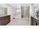 Bright bathroom with double vanity, granite countertops, tile floors, shower, and tub at 5653 Sw 50Th Ter, Ocala, FL 34474