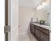 Modern bathroom featuring double sink, granite countertops, and tile flooring at 5653 Sw 50Th Ter, Ocala, FL 34474