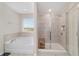 Bright bathroom with separate soaking tub and shower, granite countertops and tile floors at 5653 Sw 50Th Ter, Ocala, FL 34474