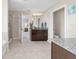 Bright bathroom with double vanity, granite countertops, tile floors, shower, and tub at 5653 Sw 50Th Ter, Ocala, FL 34474