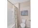 Bathroom with a shower/tub, floral shower curtain, and a white toilet at 5653 Sw 50Th Ter, Ocala, FL 34474