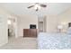 Bright bedroom with ceiling fan, plush carpet, and access to an ensuite bathroom at 5653 Sw 50Th Ter, Ocala, FL 34474