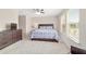 Sunny bedroom featuring a ceiling fan, plush carpeting, and natural light from large windows at 5653 Sw 50Th Ter, Ocala, FL 34474