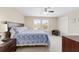 Comfortable bedroom featuring neutral walls, carpet, ceiling fan, and coordinating wood furniture at 5653 Sw 50Th Ter, Ocala, FL 34474