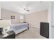 Cozy bedroom featuring neutral walls, ceiling fan, carpet and a dresser at 5653 Sw 50Th Ter, Ocala, FL 34474