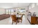 Charming dining area boasts natural light, tile floors, and sliding glass doors to backyard at 5653 Sw 50Th Ter, Ocala, FL 34474