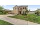 Charming two-story home featuring stone accents, three-car garage, and manicured lawn at 5653 Sw 50Th Ter, Ocala, FL 34474