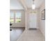 Bright foyer with tile flooring, wood floors, and an arched entryway into the living spaces at 5653 Sw 50Th Ter, Ocala, FL 34474