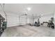 Spacious three car garage with white walls and concrete flooring at 5653 Sw 50Th Ter, Ocala, FL 34474