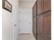 Hallway featuring a door and cabinetry for storage at 5653 Sw 50Th Ter, Ocala, FL 34474